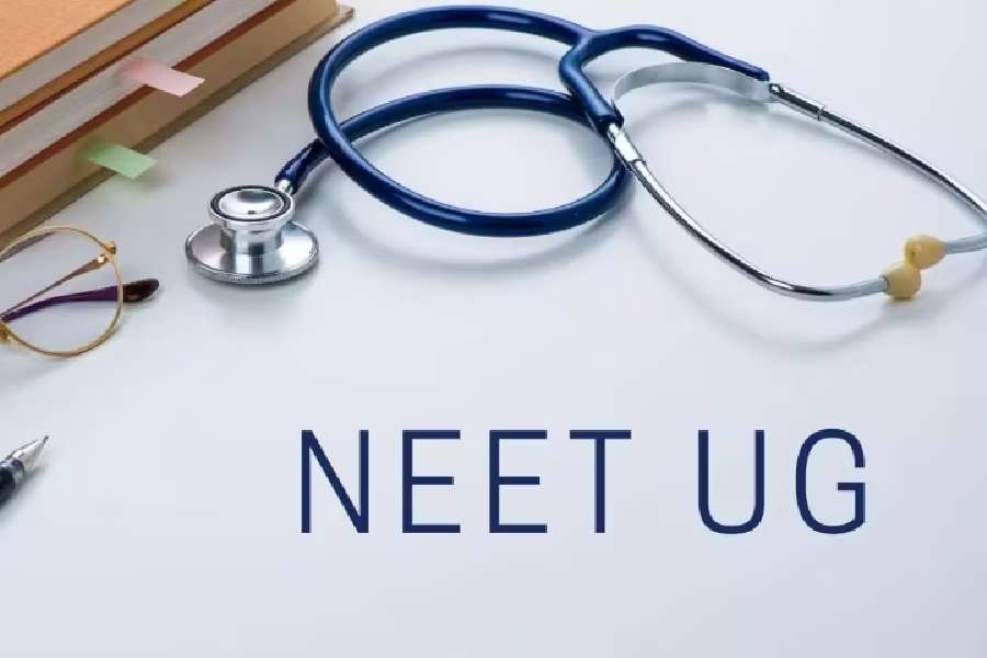 A picture depicts about NEET UG exam. Here a Stethoscope and a spectacles are visible. 